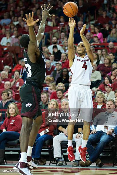 Jabril Durham of the Arkansas Razorbacks shoots a jump shot over Travis Daniels of the Mississippi State Bulldogs at Bud Walton Arena on January 9,...
