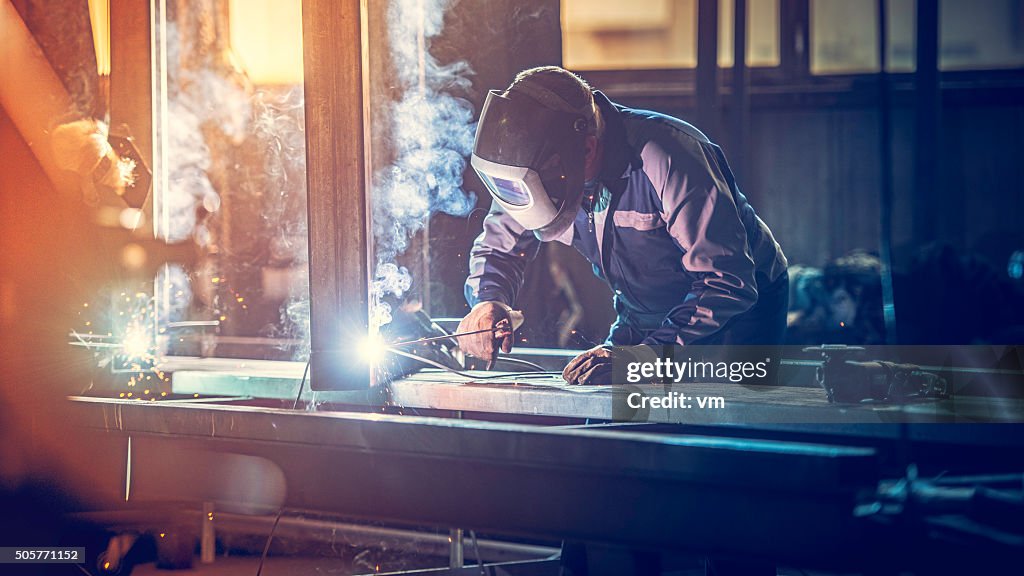 Industrial worker with welding tool