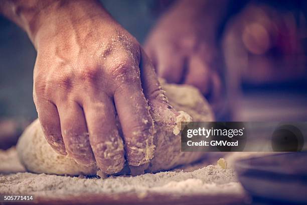 kneading dough with hands on the table - hands kneading stock pictures, royalty-free photos & images