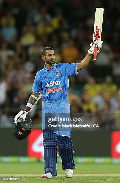 Shikhar Dhawan of India celebrates and acknowledges the crowd after scoring a century during the Victoria Bitter One Day International match between...