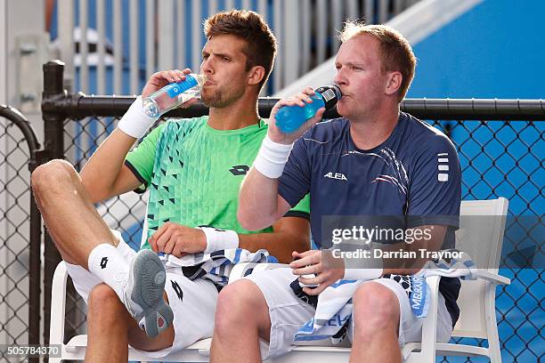 James Duckworth of Australia and John Millman of Australia take a break in their first round match against Lukas Dlouhy of the Czech Republic and...