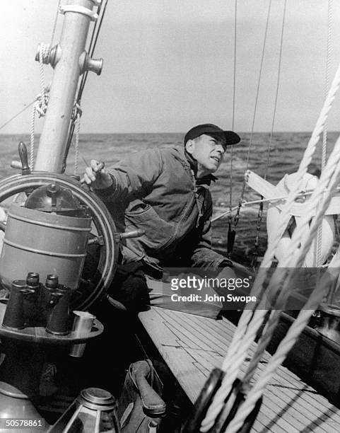 Actor Humphrey Bogart sailing his boat.