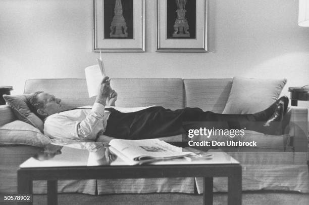 Host Art Linkletter reading on the couch.