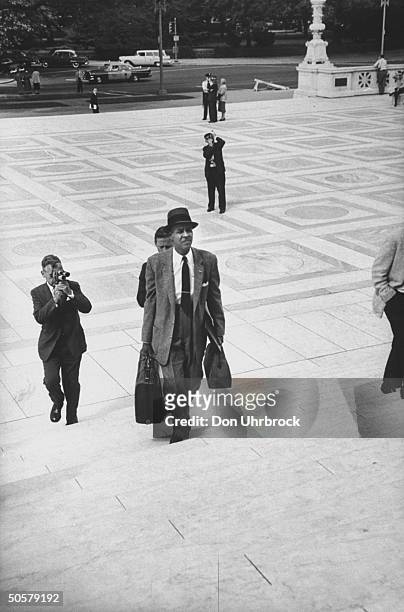 Executive Secretary Roy Wilkins walking up the stairs.