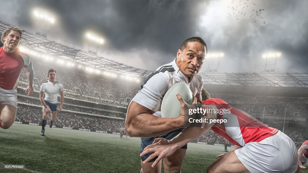 Rugby Player Running With Ball Whilst Being Tackled During Game