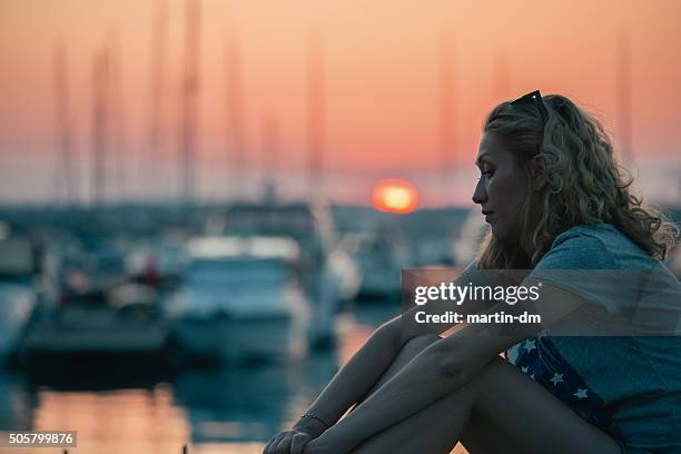 depressed woman at the yacht port - psychiatric ward stock pictures, royalty-free photos & images