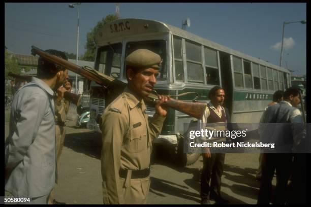 Local policeman by bus after bomb explosion at bus station, re radical Kashmiri separatist movement.