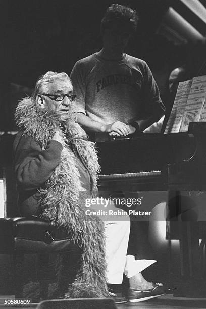 Composer Leonard Bernstein, at the piano in a feather boa, performing at the 100th birthday tribute to composer Irving Berlin at Carnegie Hall.