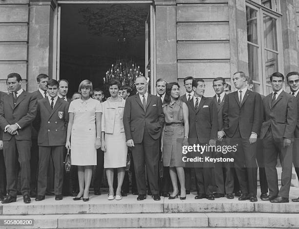 French Prime Minister Georges Pompidou posing for a portrait with a group of French Olympic medal winners; Joseph Gonzales, Christine Caron,...