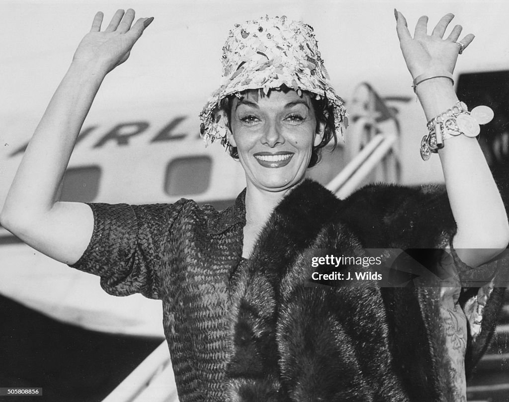 Jane Russell R Portrait of actress Jane Russell waving as she arrives in the country ...