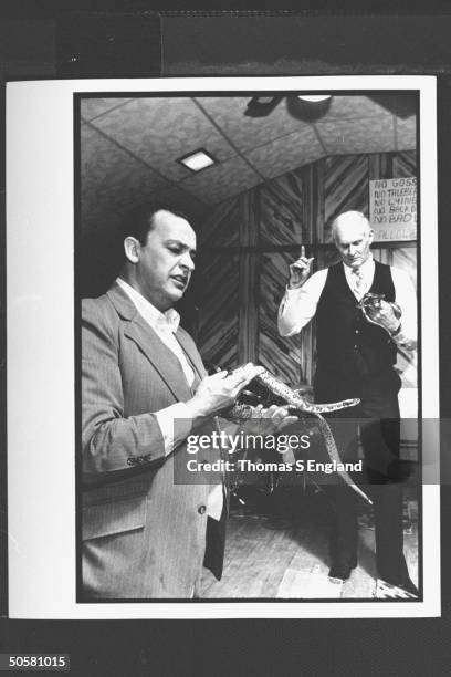 Church leader Dewey Chafin w. Ray Christian handling timber rattlesnakes during worship service at the Church of the Lord Jesus.