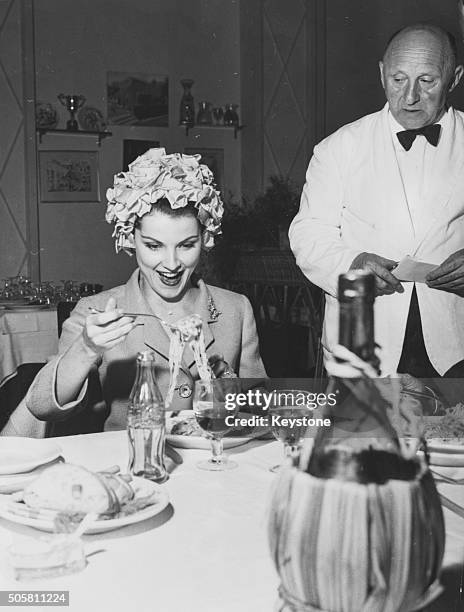 American actress Debra Paget smiling as she eats a plate of spaghetti for the first time during a visit to Rome, May 30th 1960.