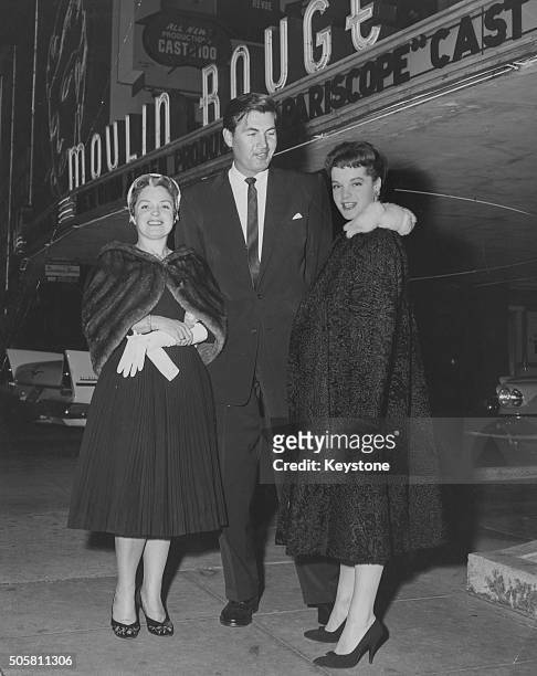 Actress Magda Schneider and her daughter Romy Schneider with actor Fess Parker outside the Moulin Rouge in Paris, circa 1955.