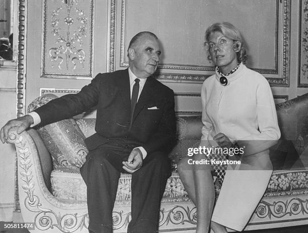 French President Georges Pompidou and his wife Claude sitting on an ornate couch together in the Elysee Palace, Paris, June 21st 1969.