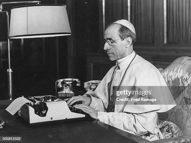 Pope Pius XII pictured working at his typewriter as he replies to peoples personal letters, January 31st 1955.