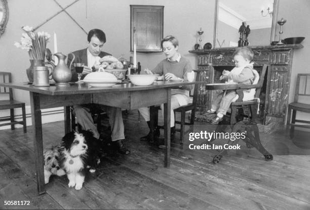 Performer Kit Hesketh Harvey, wife Katie, baby daughter Augusta and their two Tibetan Terriers having lunch at home.