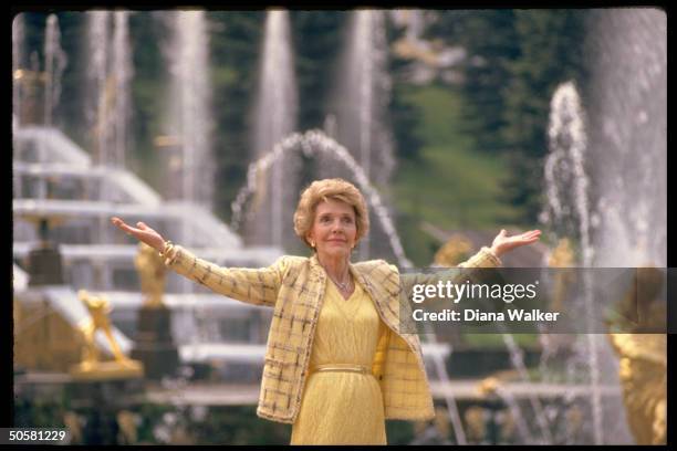 1st Lady Nancy Reagan standing in front of Samson & Lion Fountain, doing spot of sightseeing during Moscow summit.