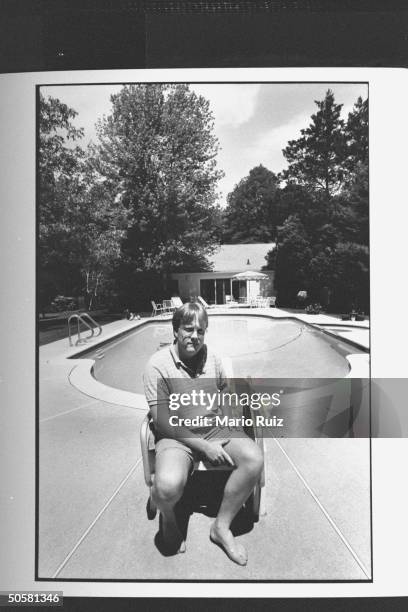 Kevin McLoughlin of 431 Hillside Avenue sitting in front of his pool; pool house behind him is a last remnant of the List house where John E. List...