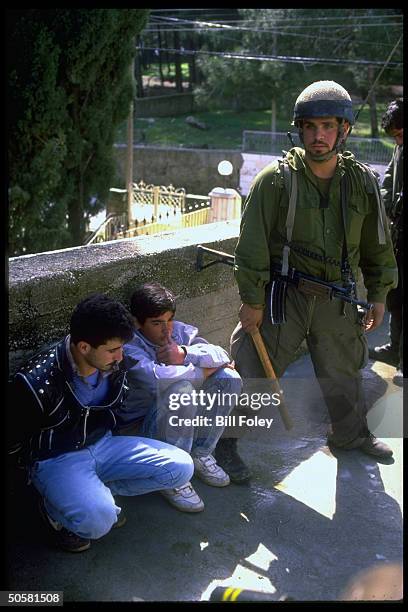 Soldier guarding 2 Arab youths detained after rock throwing intifada protest; sed Ramallah, Israeli-occupied West Bank.