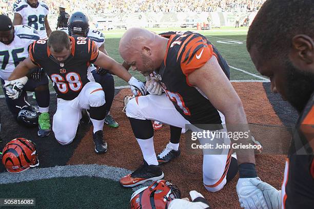 Kevin Zeitler and Andrew Whitworth of the Cincinnati Bengals share a moment in prayer after their game against the Seattle Seahawks at Paul Brown...