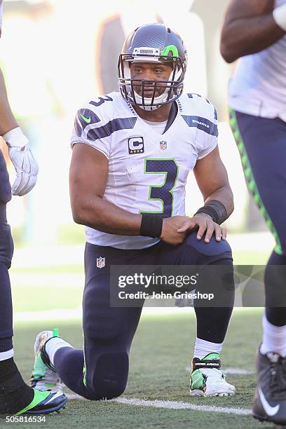 Russell Wilson of the Seattle Seahawks takes a knee in the huddle during the game against the Cincinnati Bengals at Paul Brown Stadium on October 11,...