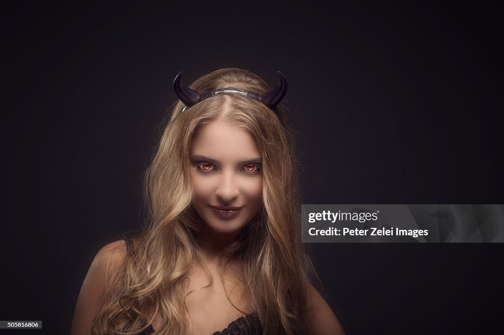 Woman wearing devil horns