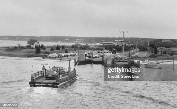 Seen from Edgartown, the small Chappaquiddick Ferry carrying three cars and some people a- cross the stretch of water that Sen. Ted Kennedy swam to...