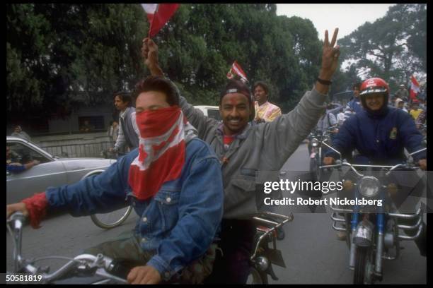 Pro-democracy protestors w. Congress Party flags & tikka smeared faces after lifting of ban on multiparty politics.