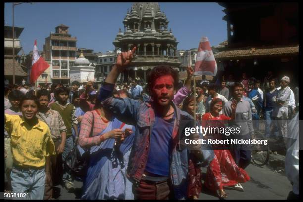 Pro-democracy protestors w. Congress Party flags & tikka smeared faces after lifting of ban on multiparty politics.