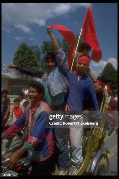 Pro-democracy youths waving flags, celebrating lifting of ban on multi-party politics.