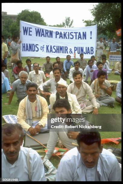 Supporters of Bharatiya Janata Party during Hindu nationalist BJP anti-Pakistan rally w. We warn Pakistan! hands of Kashmir & Punjab banner.