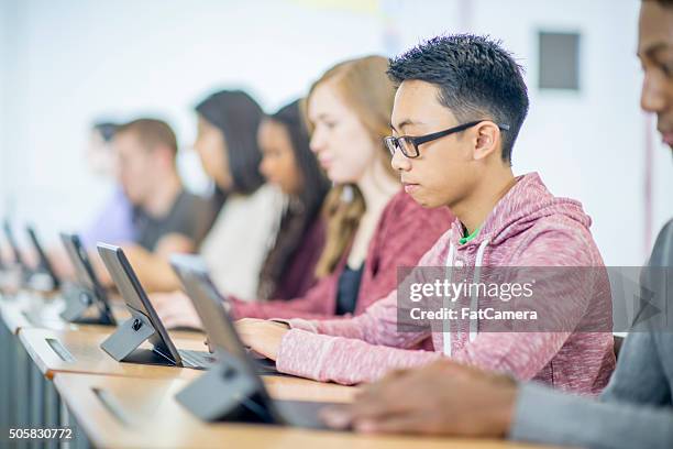 students sitting at their desks - computer class stock pictures, royalty-free photos & images