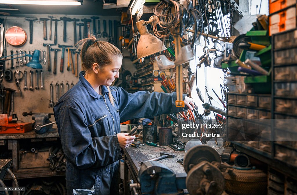 Female motor mechanic at work at the work shop.