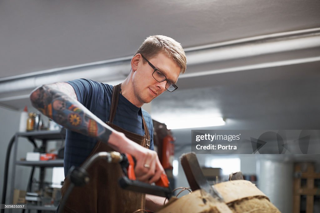 Man restoring old furniture in a small company