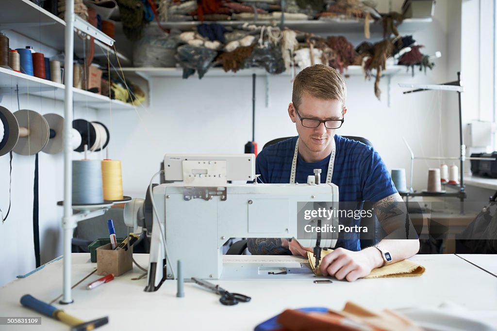 Fashion designer using sewing machine