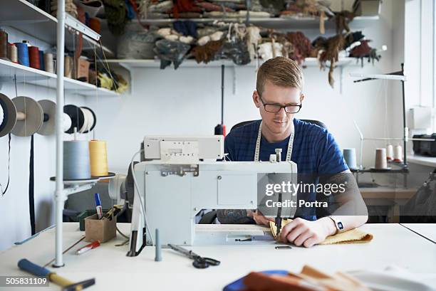 fashion designer using sewing machine - fashion designer sewing stock pictures, royalty-free photos & images