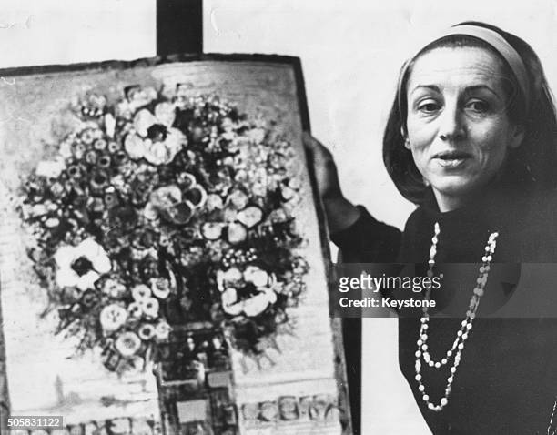 Portrait of artist Francoise Gilot, former partner of Pablo Picasso, with one of her paintings following the announcement of his death, Fulham,...