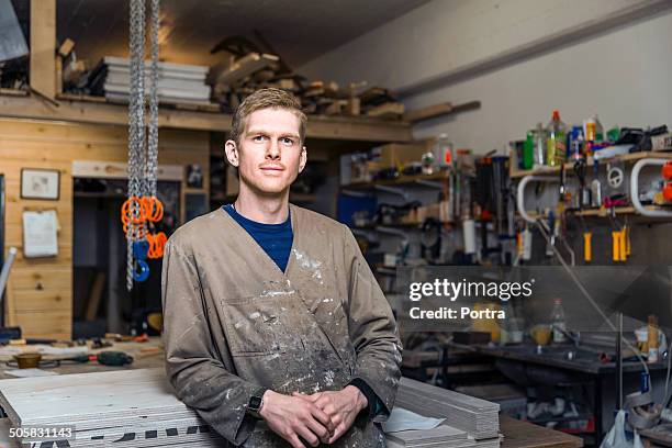 young carpenter in his work shop. - wood worker posing stock-fotos und bilder