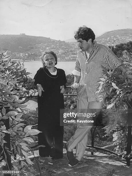 French singer Edith Piaf and her husband Theo Sarapo pictured on a balcony overlooking the sea during her convalescence at the villa 'La Serene', at...