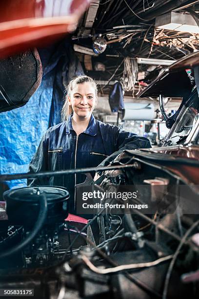 woman fixing an old car engine - reykjavik women stockfoto's en -beelden