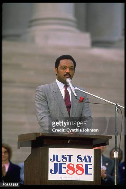 Rev. Jesse Jackson addressing campaign rally on Capitol steps during his quest for Dem. Pres. Nomination, speaking at just say Jesse sign adorned...