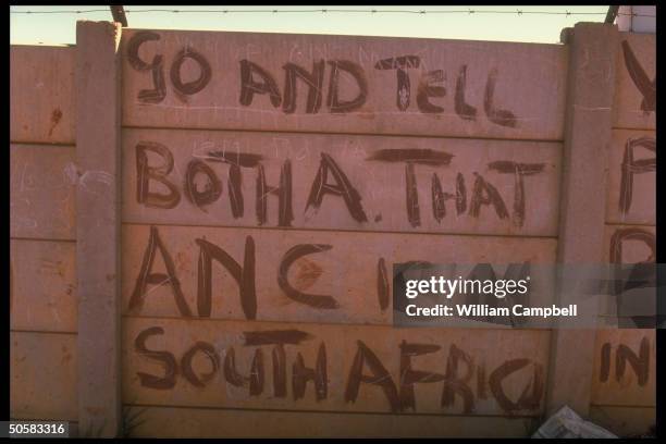 Anti-apartheid graffiti mentioning Pres. Botha adorning wall .