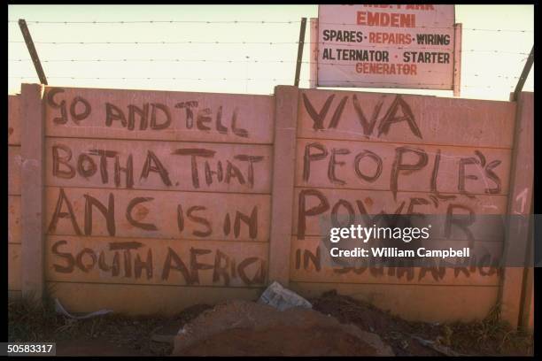 Anti-apartheid graffiti mentioning Pres. Botha adorning wall .
