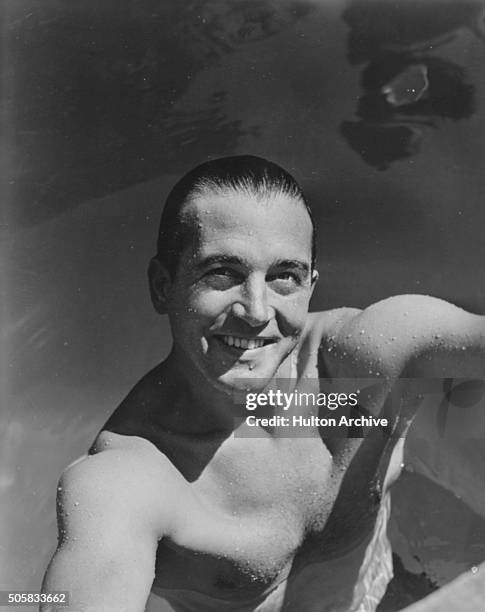 Portrait of actor John Payne in a swimming pool, circa 1945.