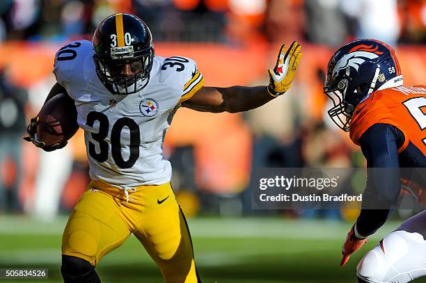 Jordan Todman of the Pittsburgh Steelers rushes against the Denver Broncos during the AFC Divisional Playoff Game at Sports Authority Field at Mile...