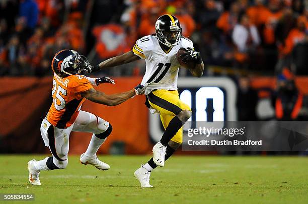 Markus Wheaton of the Pittsburgh Steelers gives a stiff-arm to Chris Harris of the Denver Broncos during the AFC Divisional Playoff Game at Sports...