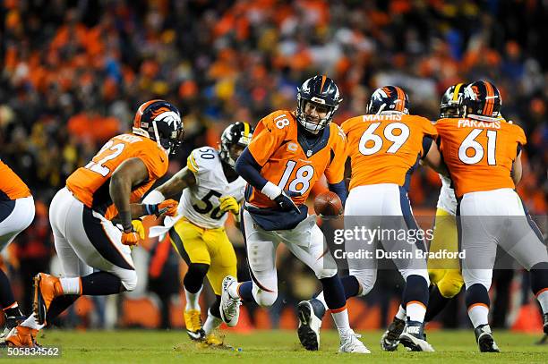 Peyton Manning of the Denver Broncos looks to hand off the ball to C.J. Anderson against the Pittsburgh Steelers during the AFC Divisional Playoff...