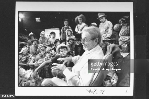 Cartoonist/ex-dir. Of animation for Warner Bros. Chuck Jones surrounded by two dozen clowns, lecturing & answering questions at the Ringling Bros. &...