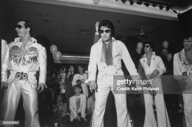 Elvis Presley impersonators competing in the Elvis Olympics; eventual overall winner Mike Albert in white sunglasses, looking much like the other...