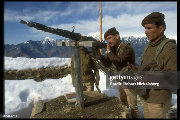 Soldiers manning machine guns at army post in disputed Kashmir border area.